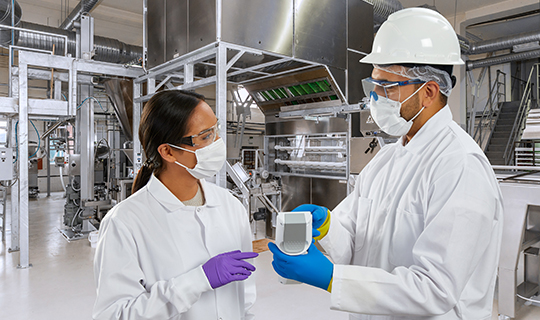 Two people in a food manufacturing facility